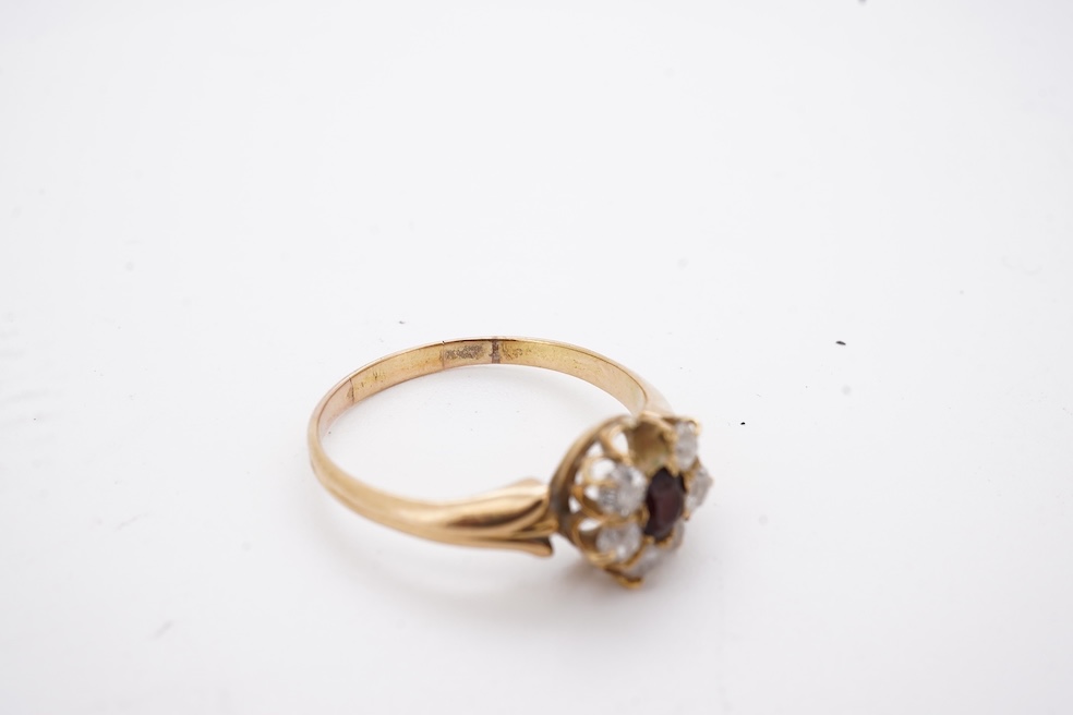 A yellow metal, garnet? and diamond set circular cluster ring (one stone missing), size P, gross weight 3 grams. Condition - poor